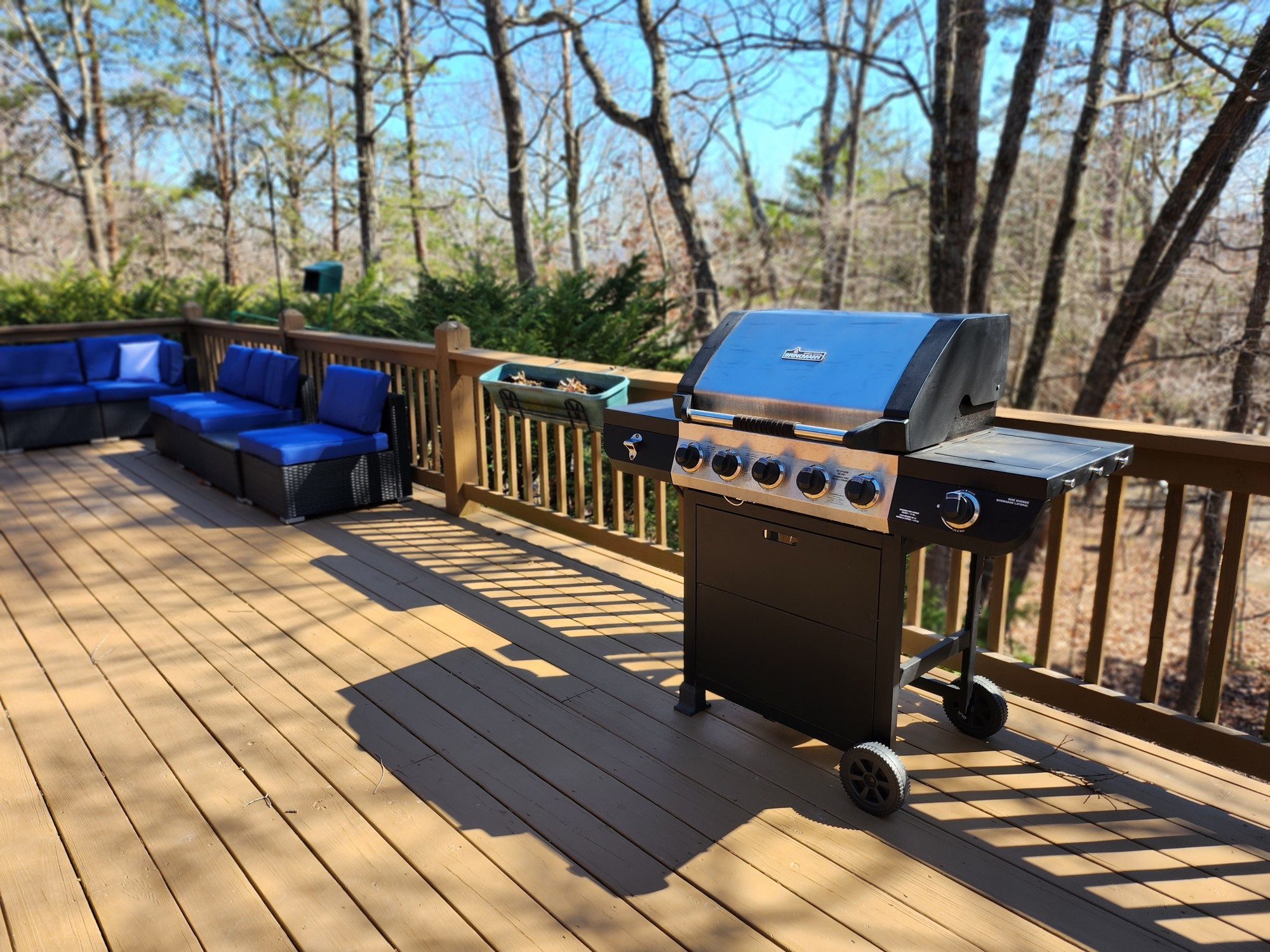 Barbecue grill and lounge seating on the deck