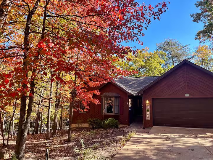 Exterior of the home surrounded by autumn trees