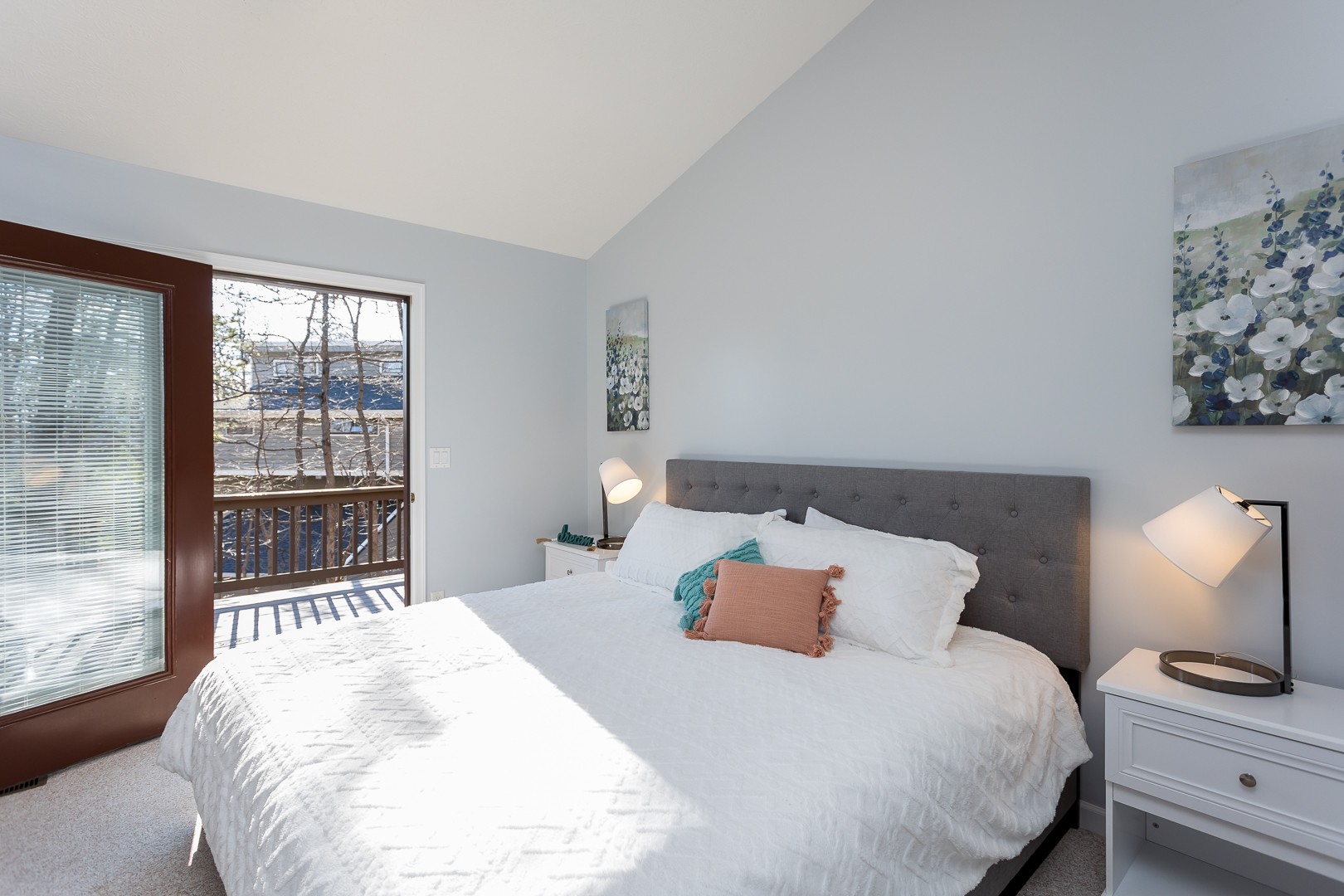 King bed beside an open door to the deck